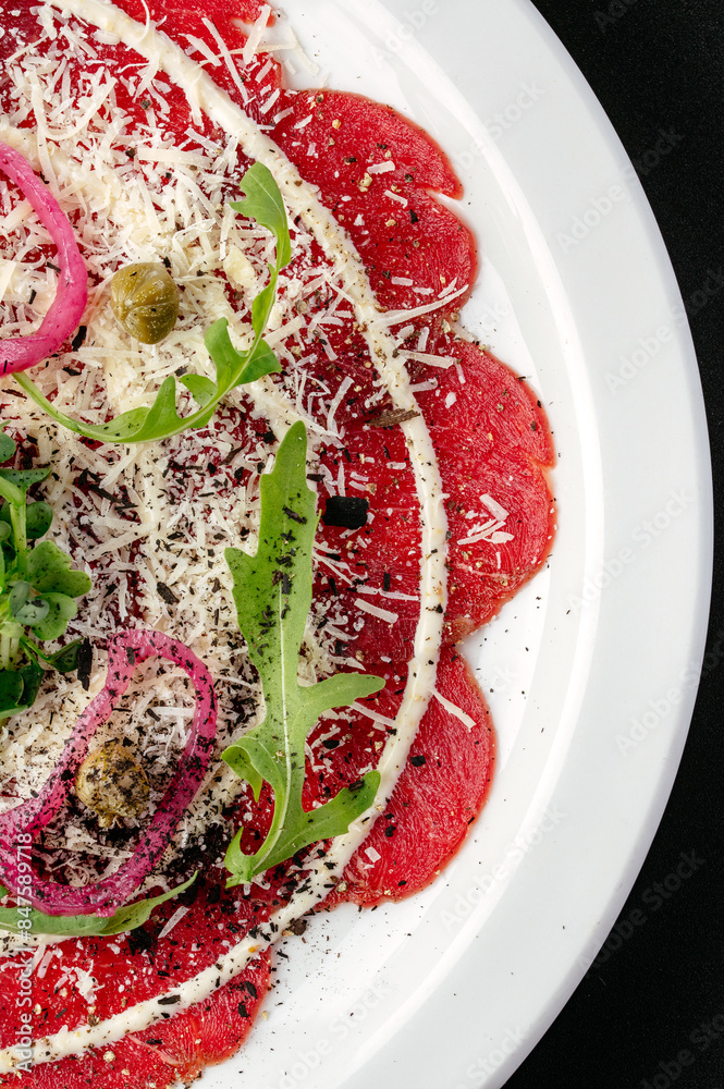 Canvas Prints marbled beef tartare on a plate with sauce, herbs and capers