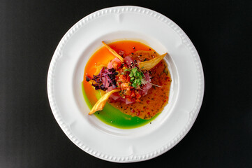 tuna tartare with sauce and nachos on a plate