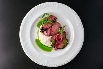 grilled beef tenderloin with sauce on a plate