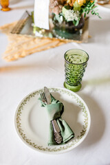 Green cut glass goblet with vintage place setting
