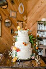 Fall avant-garde  wedding cake with autumn flowers and cake figurine