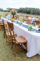 Fall banquet table set for wedding reception on a farm