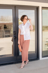 Obraz premium Women walking outside putting on sunglasses