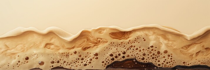 Coffee foam close-up with rich texture and dark liquid bubbles, beige background and ample copy space for text integration.