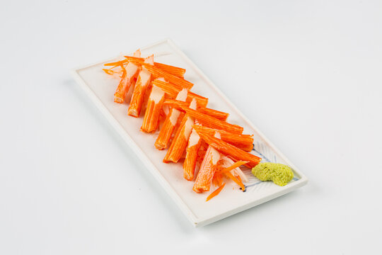 Crab sticks are placed on a plate and ready to serve.