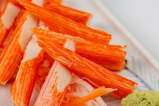 Crab sticks are placed on a plate and ready to serve.