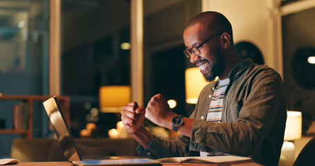 Happy, black man and night with laptop in celebration for winning, promotion or profit at office. Excited African, male person or winner with smile on computer for investment, achievement or trading