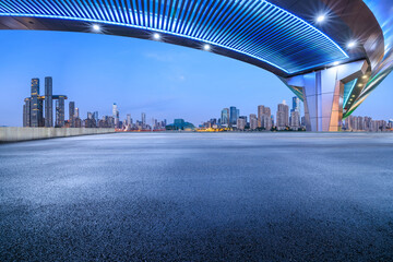 Asphalt road square and bridge with modern city buildings scenery at night in Chongqing