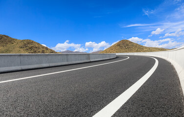 Asphalt highway road and mountain natural landscape under the blue sky