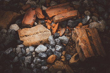 A pile of rubble with a few bricks and rocks. Scene is one of destruction and decay