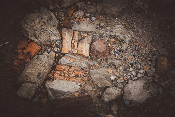 A pile of rocks and rubble with a dark background