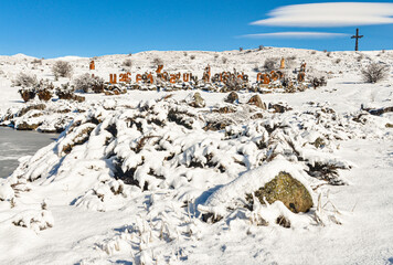 snow covered Armenian Alphabet Memorial Park and Holy Cross monument in winter (Artashavan, Armenia)
