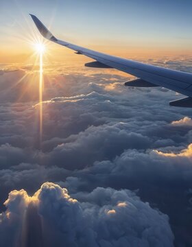 Airplane wing in sunset sky.