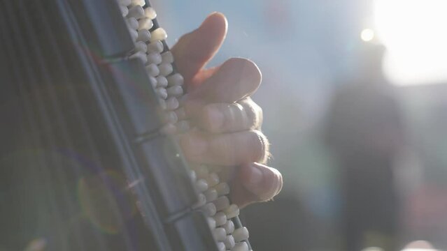 Details of fingers playing accordion, slow motion