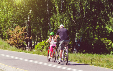 Cyclists ride on the bike path in the city Park
