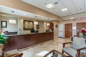 Professional Photography of the welcoming reception area with friendly staff and comfortable seating for visitors awaiting meetings, Generative AI