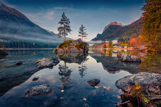 Dramatic autumn scene of Hintersee lake. Misty morning view of Bavarian Alps on the Austrian border, Germany, Europe. Beauty of nature concept background.