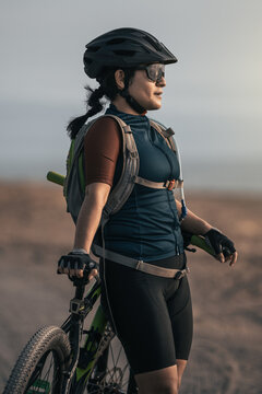 A woman stood enjoying the sunshine whilst out desert biking.
