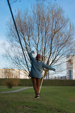 Young man balancing on slackline.