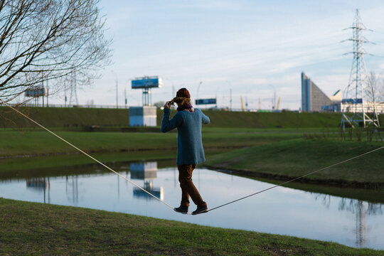 Young man balancing on slackline.