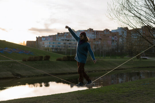 Young man balancing on slackline.