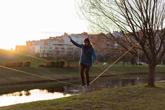 Young man balancing on slackline.