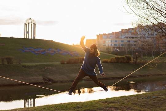 Young man balancing on slackline.