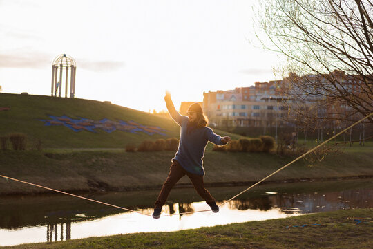 Young man balancing on slackline.