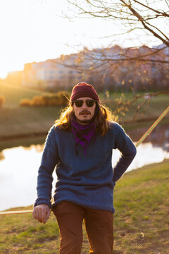 Young man sitting on a slackline.