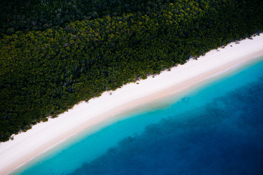 Aerial view of isolated beach with white sands and crystal blue waters