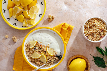 yogurt in a bowl with granola and lemon