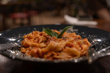 Traditional Italian linguini pasta with tomatoes and basil