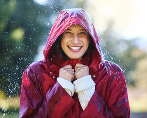 Outdoor, portrait and woman with raincoat for winter season and walking in park for relax. Female...