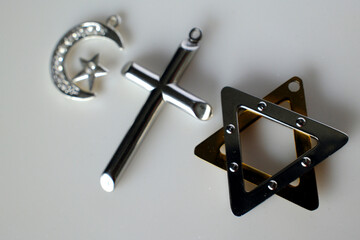 Religious symbols : Jewish Star of David, Muslim Star and Crescent and Catholc Cross. Interreligious, interfaith and spirituality concept.
