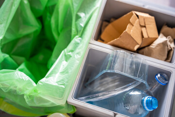 Household bins for waste sorting in the kitchen for recycle. Plastic, paper, bio and mixed waste. Sorting waste at home concept