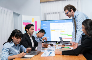 Project manager planning schedules for business task at meeting room, Gantt chart software show on...