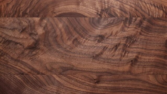 Dark walnut wood desktop background. Dark walnut wood texture background. Desktop background moving up and down. Empty desktop.