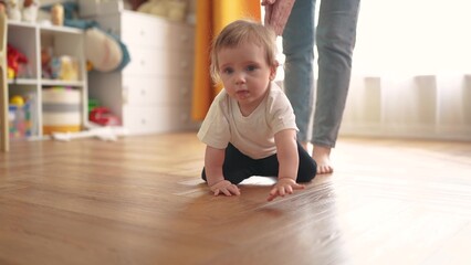 baby crawls. happy family a kid dream concept. baby crawls takes first steps to study indoors. mother teaches baby to crawl takes first steps. lifestyle children learning concept
