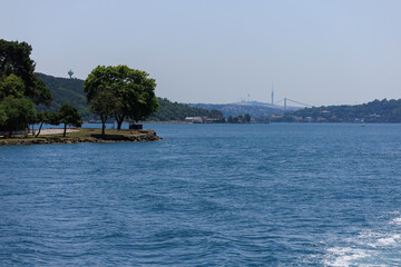Blue seascape overlooking the coast. View of the Bosphorus in Istanbul city on sunny summer day, in a public place.
