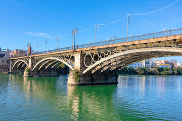 Puente de Triana in Seville Spain. Iron arch bridge connecting the Triana neighborhood to Seville center