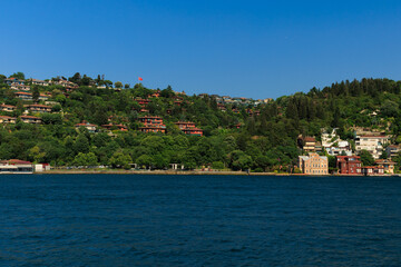 Fototapeta premium Blue seascape overlooking the coast. View of the Bosphorus in Istanbul city on sunny summer day, in a public place.