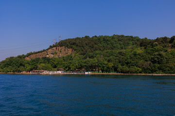 Blue seascape overlooking the coast. View of the Bosphorus in Istanbul city on sunny summer day, in a public place.