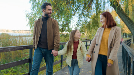 Caucasian happy family weekend holiday at nature outdoors laughing smiling in city autumn park...