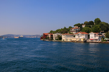 Obraz premium Blue seascape overlooking the coast. View of the Bosphorus in Istanbul city on sunny summer day, in a public place.