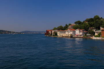Fototapeta premium Blue seascape overlooking the coast. View of the Bosphorus in Istanbul city on sunny summer day, in a public place.