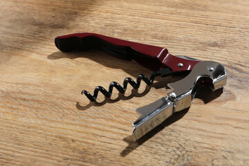 One corkscrew (sommelier knife) on wooden table