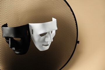 Theater arts. Two masks and honeycomb grid on beige background, top view. Space for text
