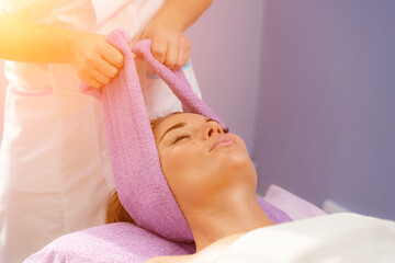 Relaxing massage. European woman getting head massage in spa salon, side view