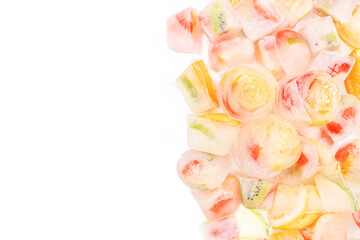 Fruit ice cubes with organic berries on a white background top view. copy space, summer background