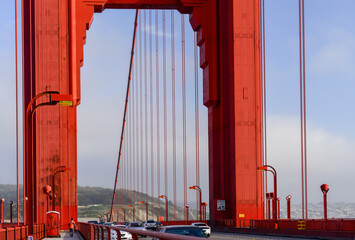 People walking and cars driving on Golden Gate Bridge. San Francisco. California.